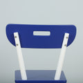 Blue plastic chair back with rectangular cut-out handle and white metal legs bolted to seat on light gray background