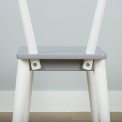 Minimalist gray and white wooden chair with modern design and sleek lines.