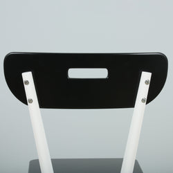 Modern black and white chair with unique backrest design.