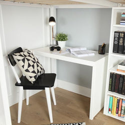 Compact modern study nook with white desk, black chair, and bookshelf filled with colorful books, optimized for small spaces.