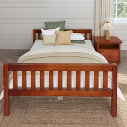 Rustic wooden bed frame in cozy bedroom with nightstand and decorative pillows.