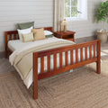 Cozy farmhouse bedroom with wooden slatted bed frame, neutral beige layered bedding and textured throw pillows, wooden nightstand with lamp, linen curtains, shiplap wall, woven jute rug and potted fiddle leaf fig