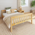 Cozy farmhouse bedroom with light wood bed, neutral bedding, textured pillows, woven jute rug, bedside lamp and potted plant