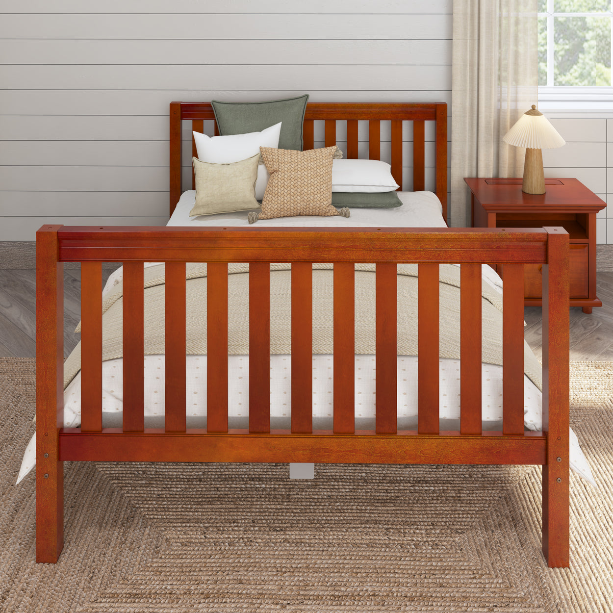 Wooden bed with green and beige decorative pillows in a modern bedroom.