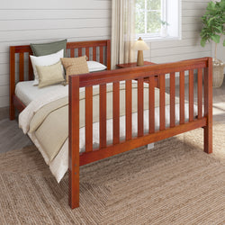 Wooden twin bed with cozy bedding and pillows in a modern bedroom setting, featuring a bedside table and decorative plant.