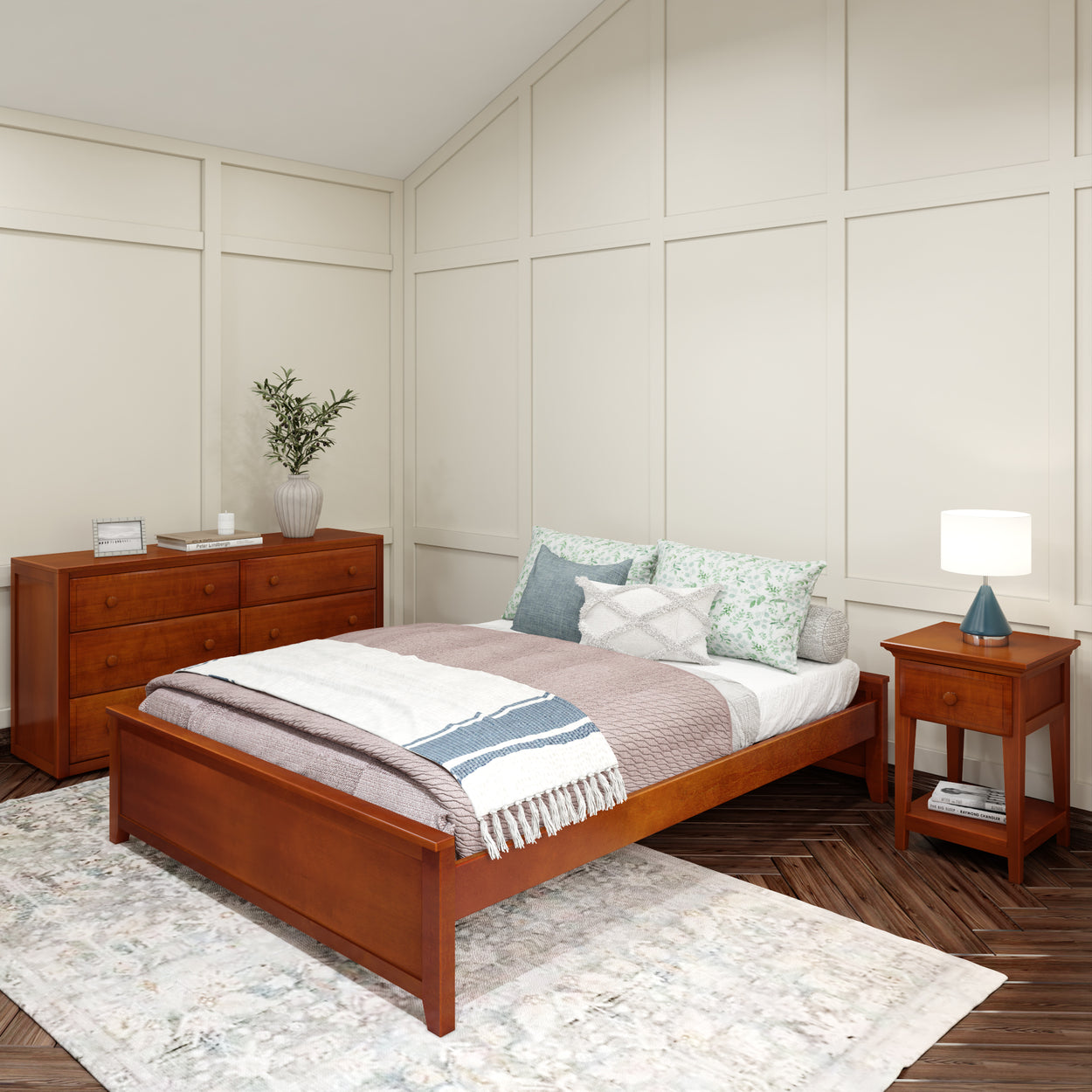 Contemporary bedroom with wooden bed frame, nightstand, and dresser, featuring a cozy bed with decorative pillows and a soft area rug.