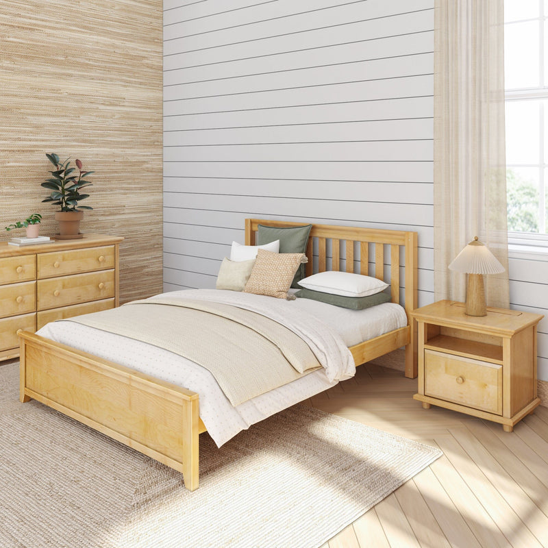 Neutral modern farmhouse bedroom with white shiplap accent wall, light wood bed and dresser, textured beige bedding, bedside lamp and potted plants.
