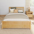 Cozy neutral bedroom with light wood bed frame, layered beige and green pillows, knitted throw, nightstand lamp and shiplap wall
