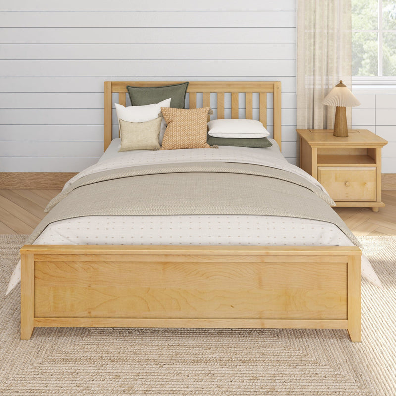 Cozy neutral bedroom with light wood bed frame, layered beige and green pillows, knitted throw, nightstand lamp and shiplap wall