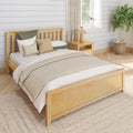 Cozy neutral farmhouse bedroom with natural wood bed frame, layered beige bedding and pillows, shiplap wall, wooden nightstand with lamp, woven rug and potted fiddle leaf fig plant