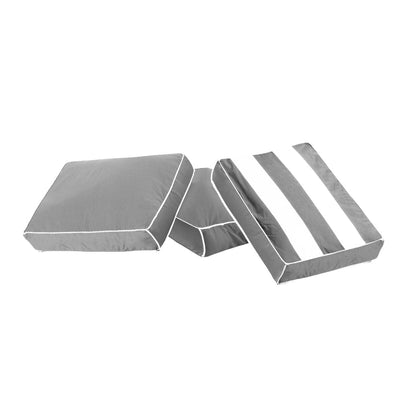 Grey outdoor seat cushions with white piping and striped design.
