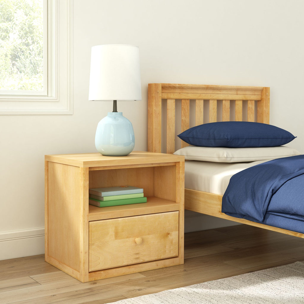 Minimalist bedroom interior with light wood nightstand, pale blue ceramic table lamp, wooden slatted bed frame, navy blue pillows and natural window light