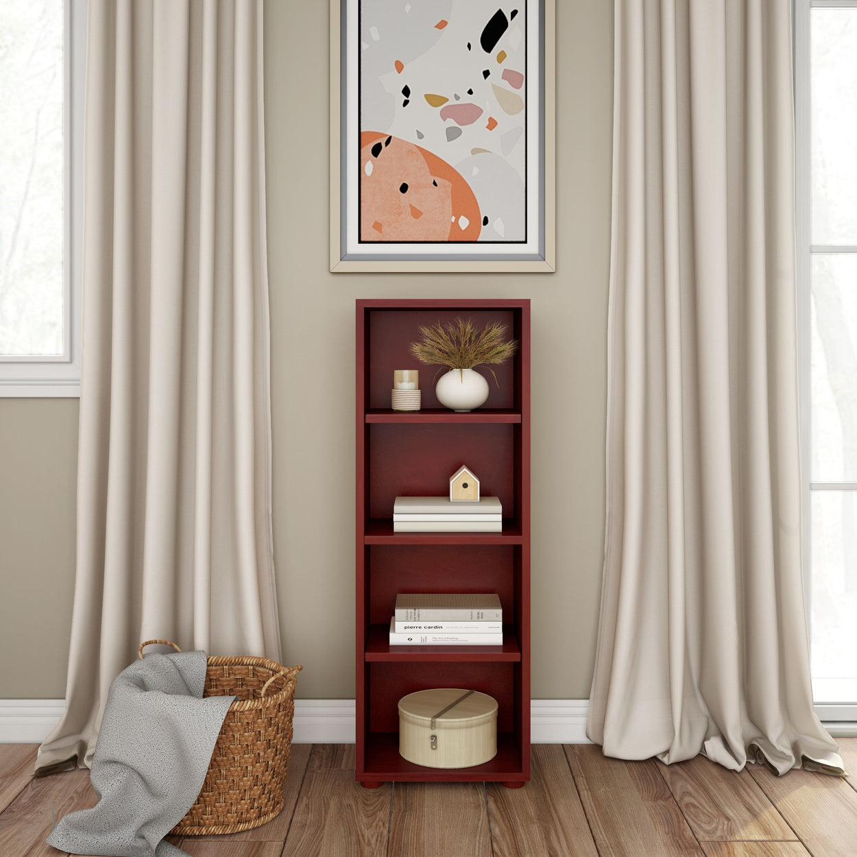 Tall red bookcase with decorative items, framed abstract art, beige curtains, and wicker basket on wooden floor in modern living room.