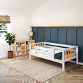 Modern toddler bed in stylish bedroom with bookshelf, plant, and lamp.