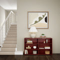 Stylish home interior with modern staircase, abstract wall art, elegant table lamp, and red bookshelf.
