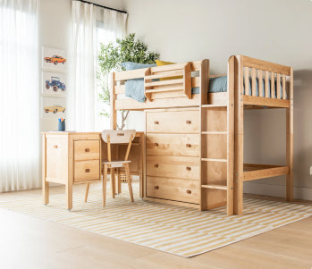 White wooden twin-over-full bunk bed with under-drawer storage, teal and pink bedding and green throw in a modern kids' bedroom.