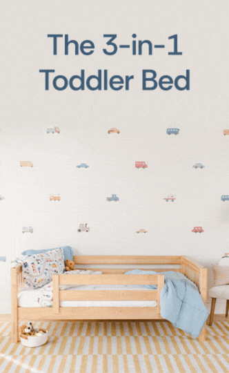 3-in-1 convertible wooden toddler bed with safety rail, blue bedding and toy-car wall decals in a modern nursery
