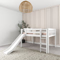 White wooden kids loft bed with slide and ladder in a neutral nursery — blush bedding, board-and-batten accent wall, rattan pendant light and potted plant in a modern farmhouse children's bedroom