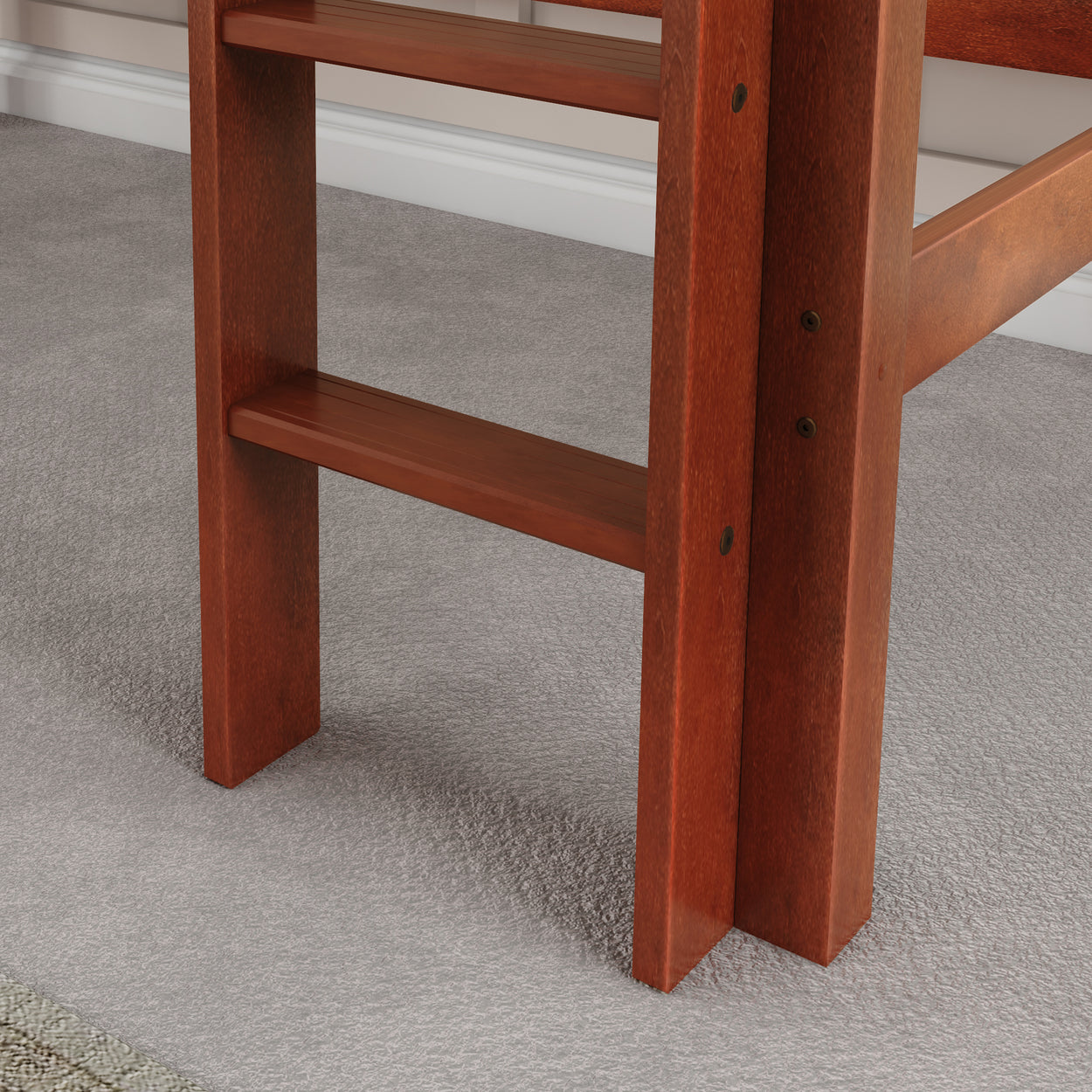 Rustic wooden bunk bed ladder detail on gray carpet flooring.