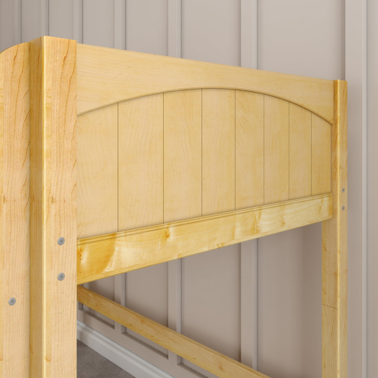 Wooden bed frame headboard in light oak finish against a beige paneled wall.