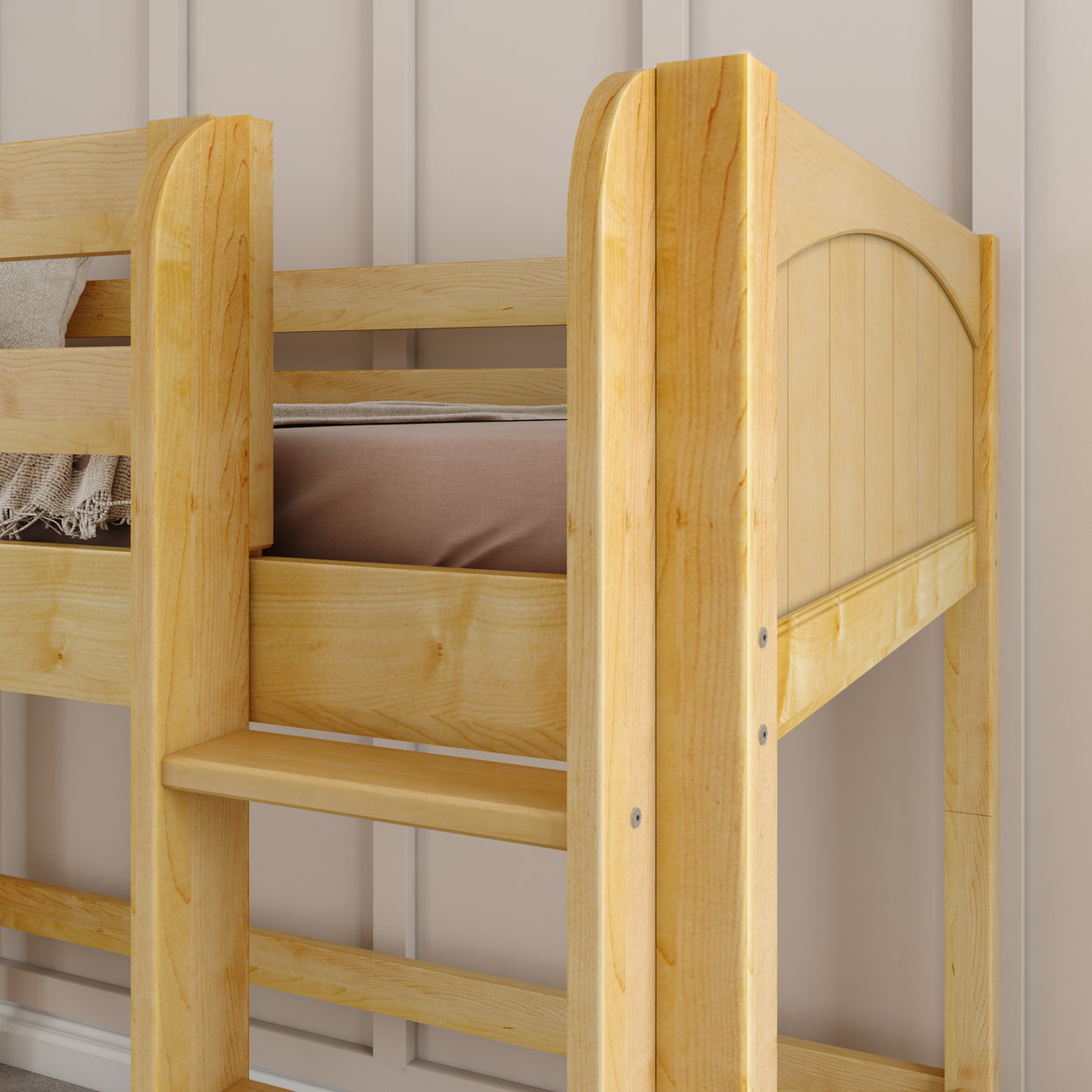 Wooden bunk bed with natural finish and beige wall background.
