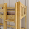 Close-up of solid light wood bunk bed showing slatted guardrail, ladder rungs, beige bedding and neutral paneled bedroom wall