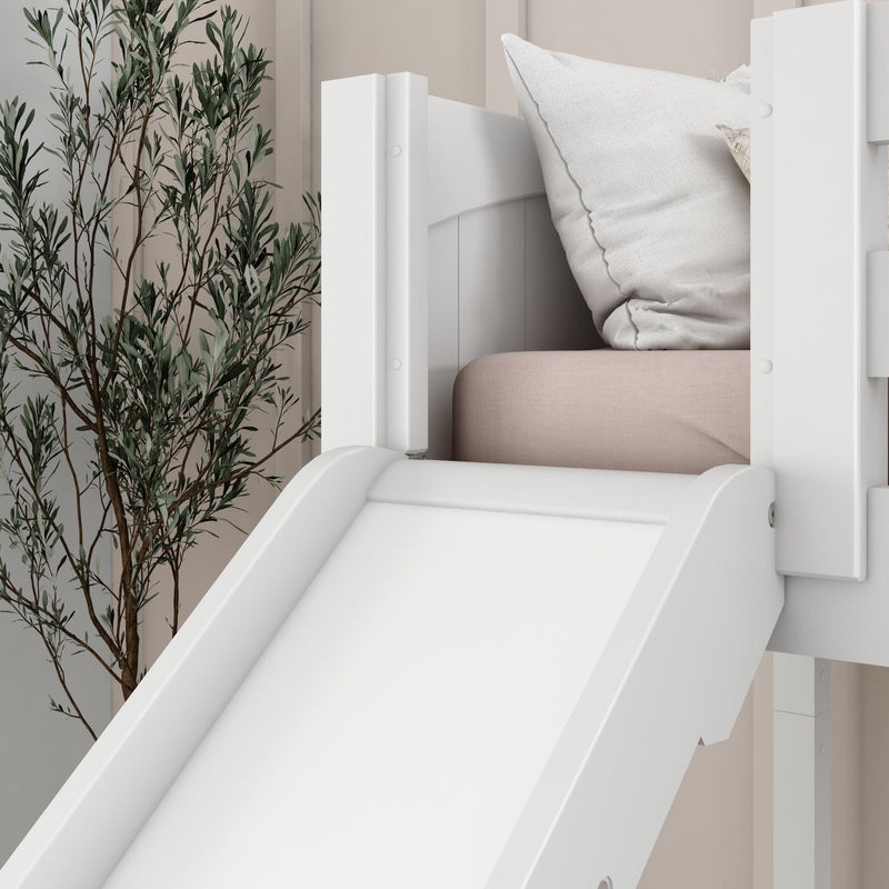 Close-up white indoor children's bed slide attached to a white wooden bunk with blush mattress, textured pillow and decorative plant