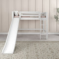 White children's loft bed with slide and ladder in a neutral beige kids' room, pale pink bedding, decorative pillows and patterned rug