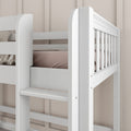 Close-up of white wooden children's bunk bed ladder and safety rail with beige bedding in modern nursery