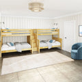 Cozy coastal-style kids' bedroom with twin-over-twin wooden bunk beds, built-in storage stairs, white shiplap walls, neutral rug, pendant ceiling light and blue accent chair