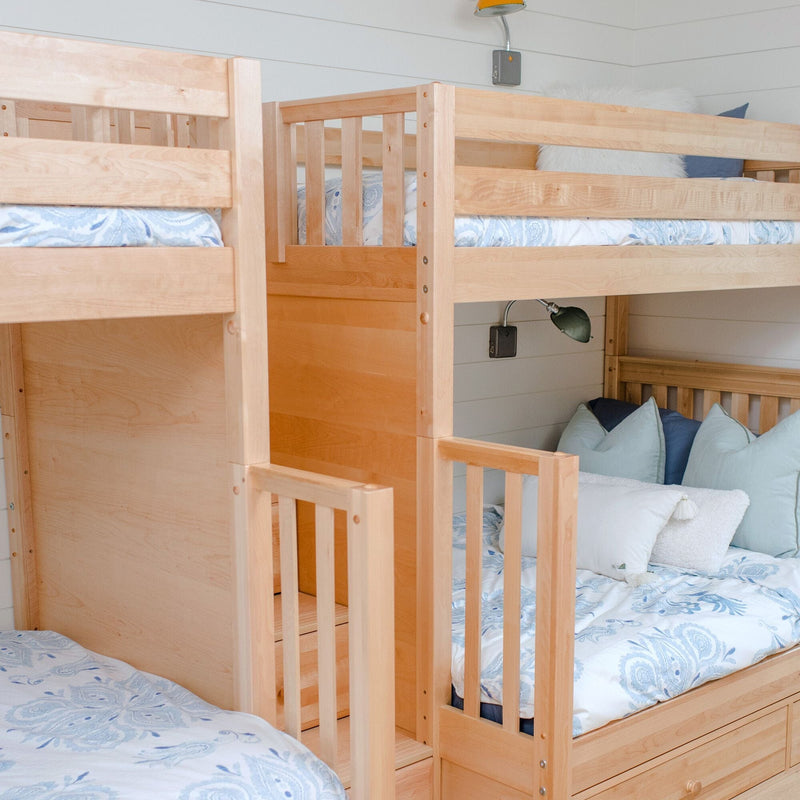 Solid maple bunk beds with built-in stairs and under-bed drawers in a coastal kids room with blue paisley bedding