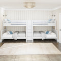 White wooden bunk beds with central staircase in a bright coastal farmhouse kids' bedroom, neutral shiplap walls, blue pillows and rattan chandelier