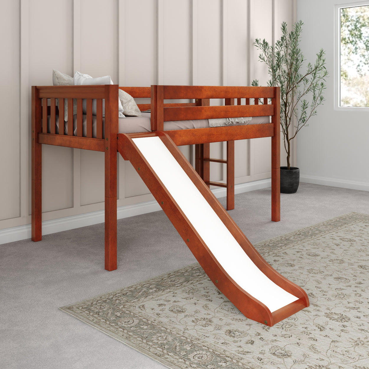 Wooden loft bed with slide in modern kids' room with beige walls and decorative plant.