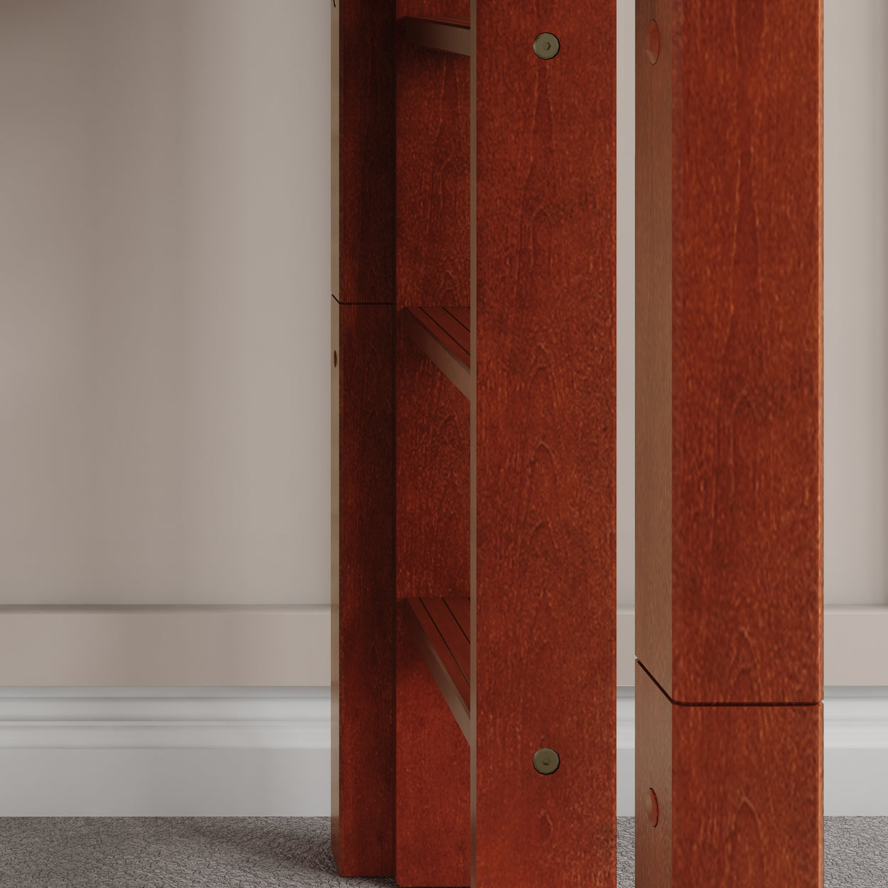 Modern wooden table legs in close-up view with a stylish design against a neutral wall background.