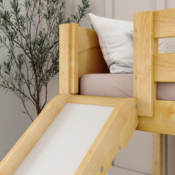Wooden loft bed with slide and cushion in modern bedroom decor next to green plant.
