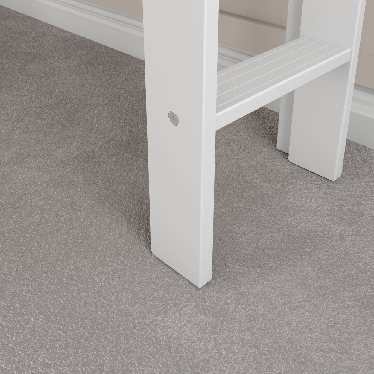 Close-up of a white step ladder leg on a gray carpet, highlighting the flooring texture and ladder detail.