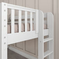 White wooden bunk bed close-up with slatted guardrail, integrated ladder and blush bedding against beige paneled wall, modern kids' loft bed with sturdy safety railing