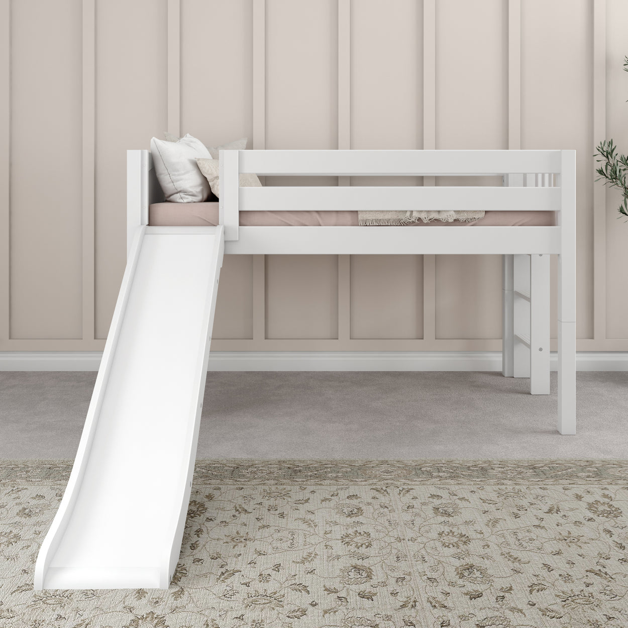 White loft bed with slide in a children's room with a beige carpet and brown wall paneling.