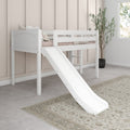 White kids loft bed with slide in modern neutral bedroom — beige paneled wall, soft pillows, patterned rug and potted plant by window