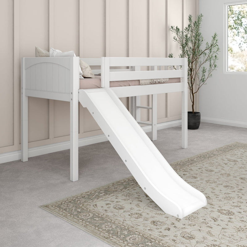 White kids loft bed with slide in modern neutral bedroom — beige paneled wall, soft pillows, patterned rug and potted plant by window