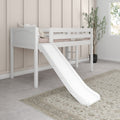 White loft bed with slide in neutral kids bedroom, space-saving children's loft bunk with pillows, beige paneled wall, potted plant and window light