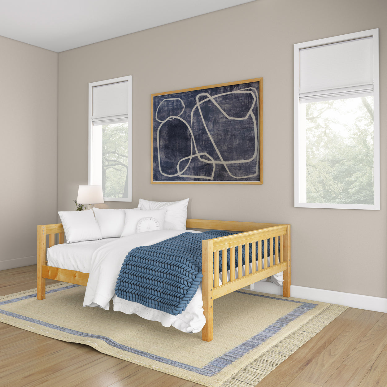 Modern bedroom with a stylish wooden daybed featuring a blue knitted blanket and decorative pillows.