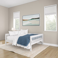 Modern bedroom with white daybed, blue knitted blanket, and minimalist decor.