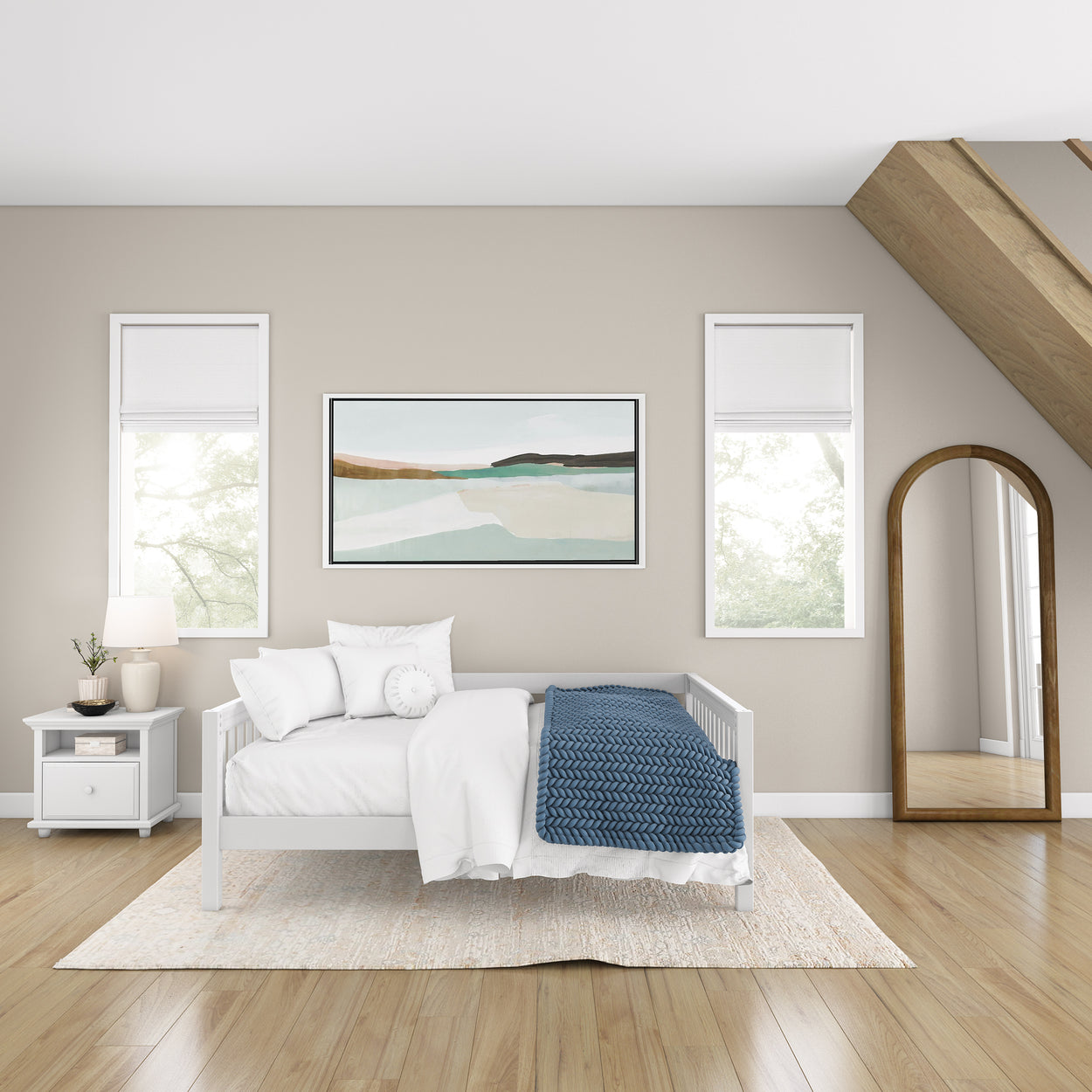 Modern bedroom with white furniture, blue throw, abstract art, and natural light.