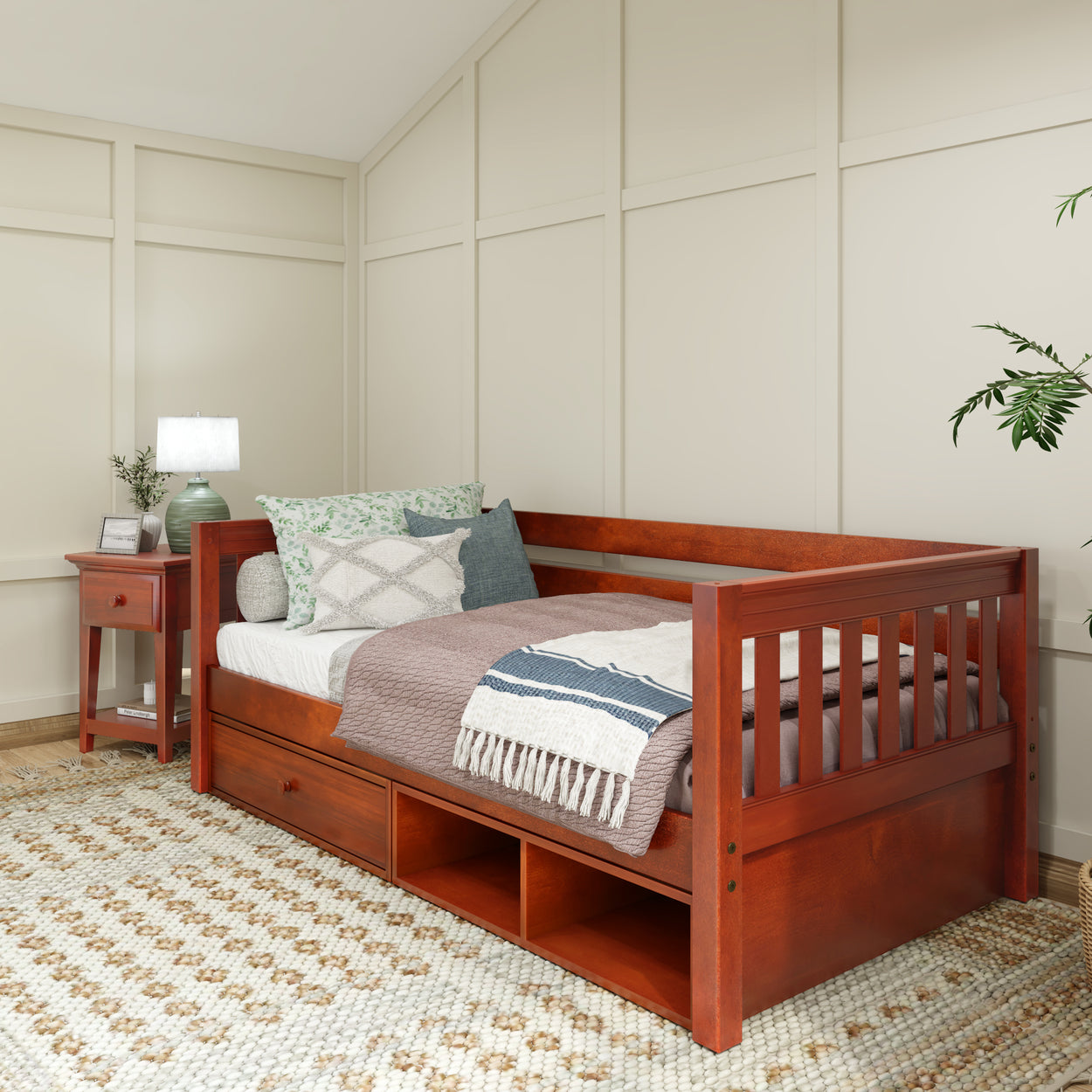 Stylish wooden daybed with storage drawers in cozy bedroom setting.