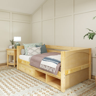 Wooden daybed with storage drawers, cozy pillows, and a throw blanket in a modern bedroom setting.