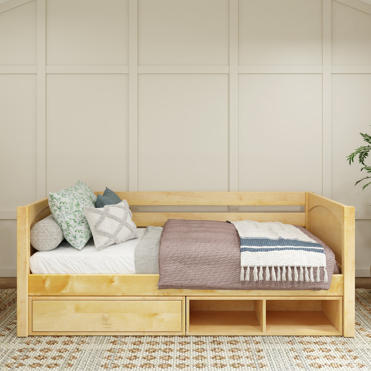 Wooden daybed with built-in storage drawers in a cozy bedroom setting.