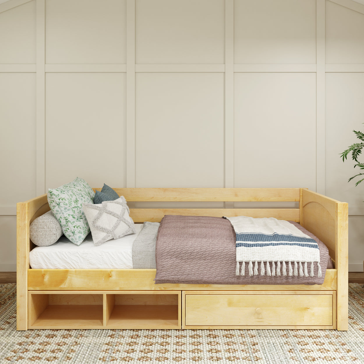 Wooden daybed with storage drawers and cushions in a cozy bedroom setting.