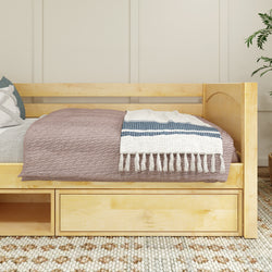 Natural wood daybed with storage drawers, draped with a cozy blanket and throw pillow in a modern bedroom setting.