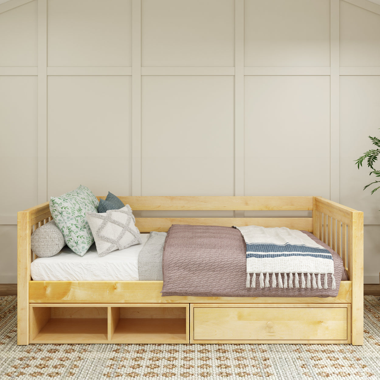 Wooden daybed with storage drawers, cozy pillows, and neutral bedding in a stylish bedroom.